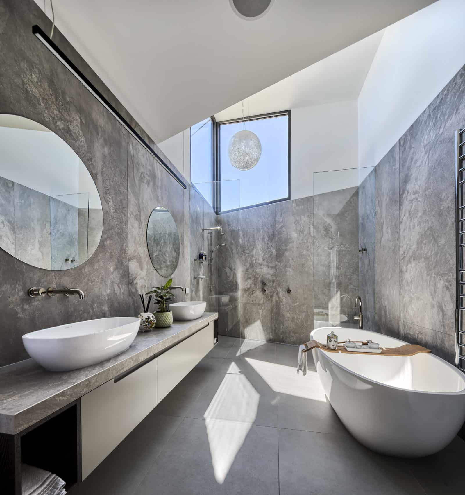 Industrial bathroom with concrete walls and skylight